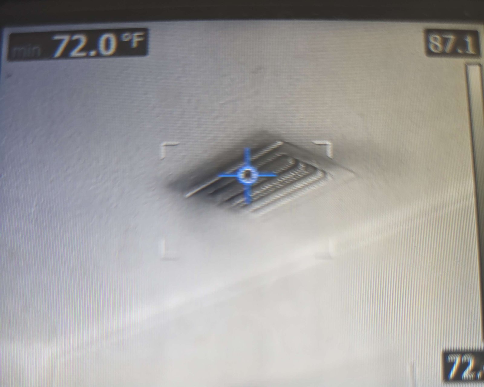 Thermal imaging camera screen showing a ceiling supply vent and its measured air temperature