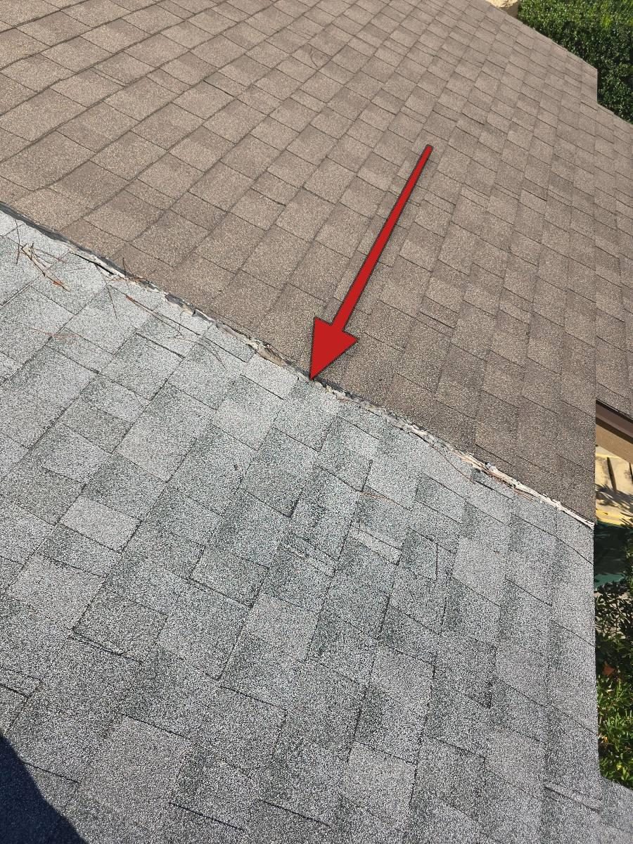 Close view of roof decking at the seam between two attached units, showing the area where a soft spot was noted during inspection