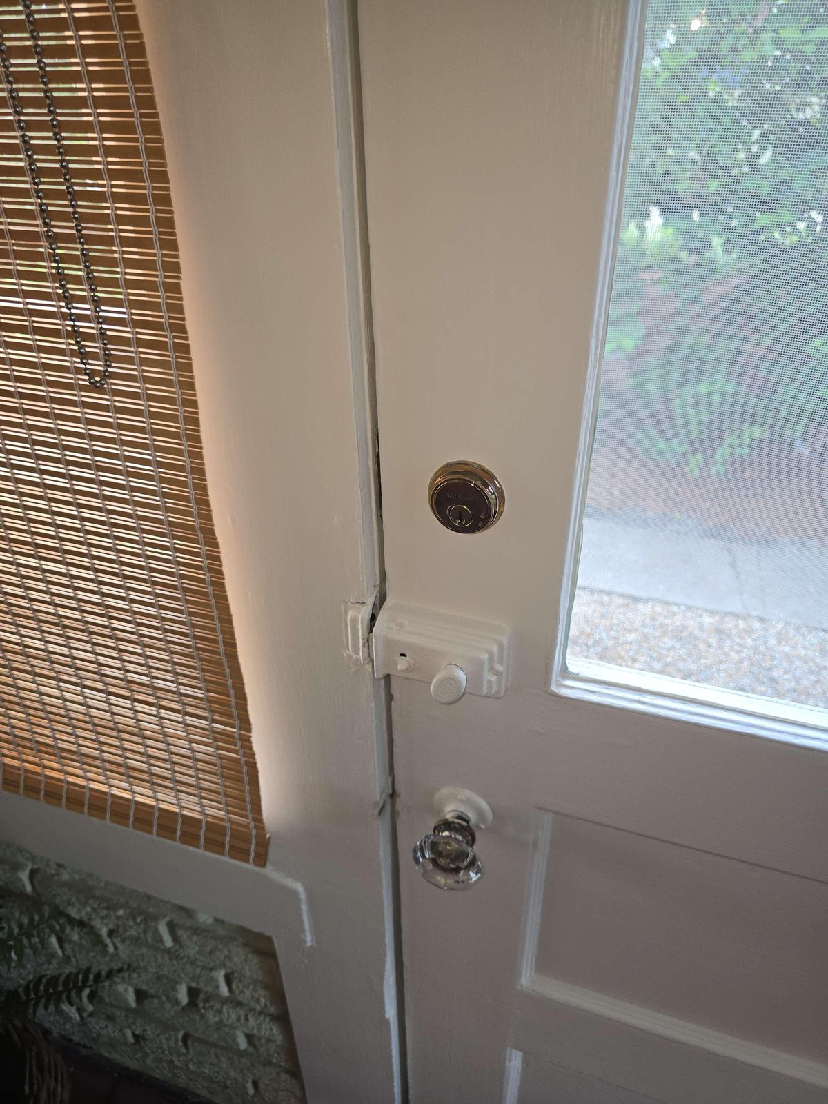 A deadbolt lock on an interior-facing side of a door, showing a keyhole where a thumb-turn lever would typically be found.